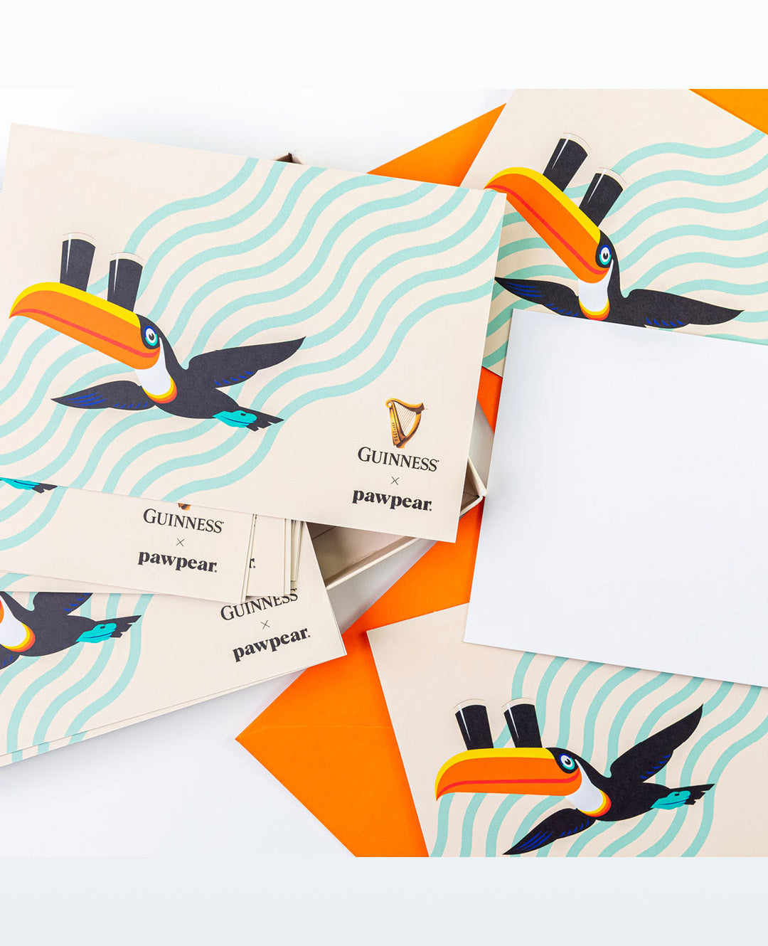 Set of cards with toucan illustrations and Guinness branding on a white background
