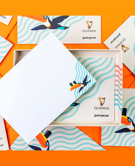 Packaging with toucan illustrations and 'Guinness pawpear' text on an orange background