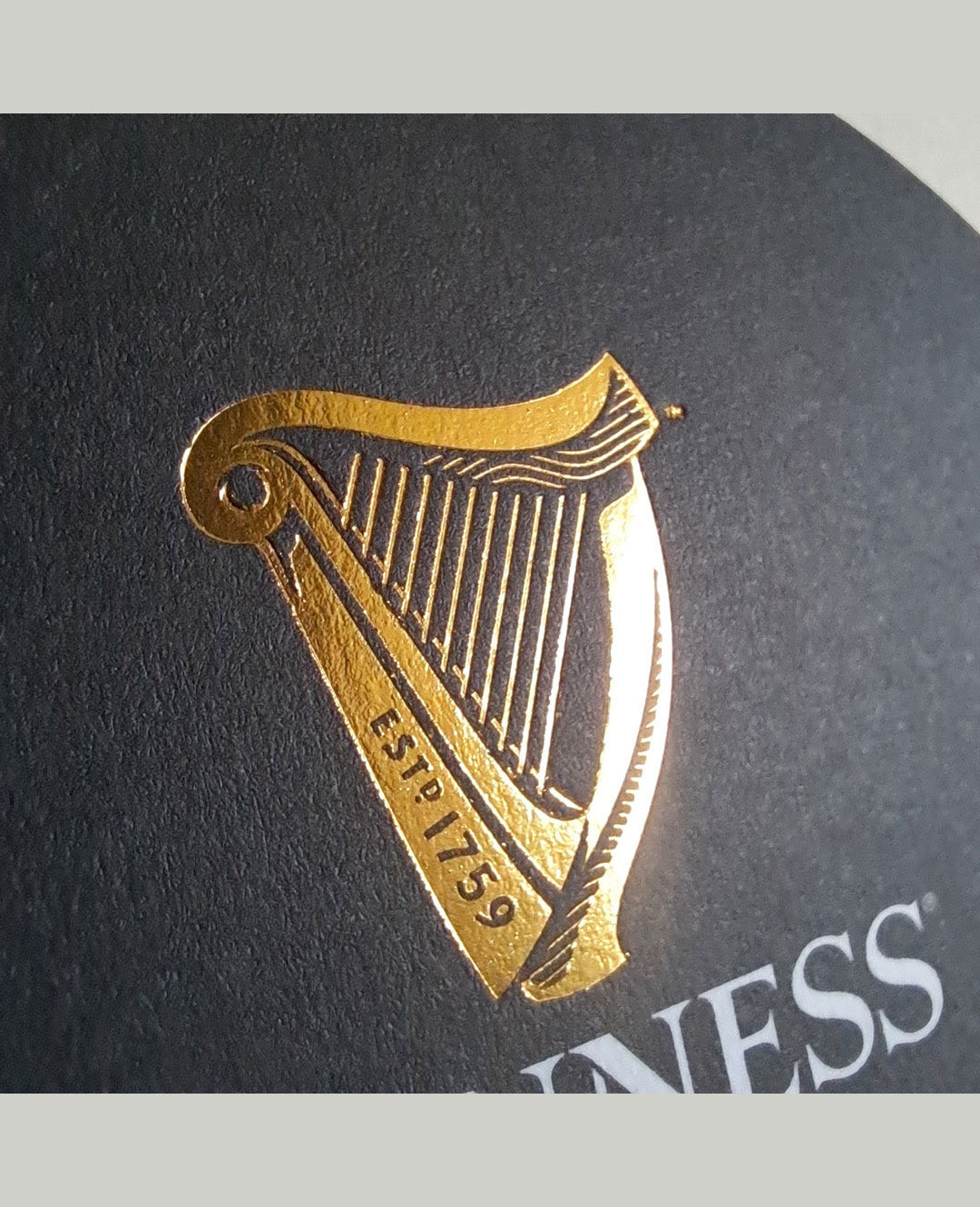 Gold harp logo on a black background with 'Guinness' branding.