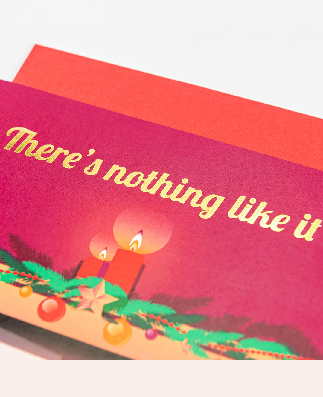 Greeting card with Christmas design and text 'There's nothing like it' on a red background.