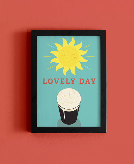 Framed artwork with a sun and Guinness illustration on a red background