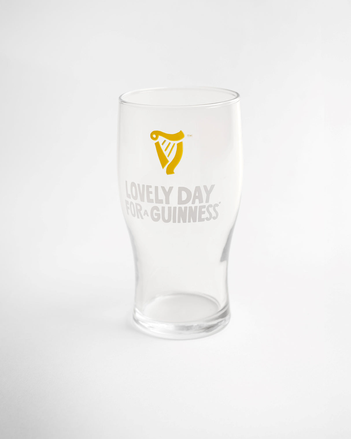 Clear glass with Guinness logo and text on a white background