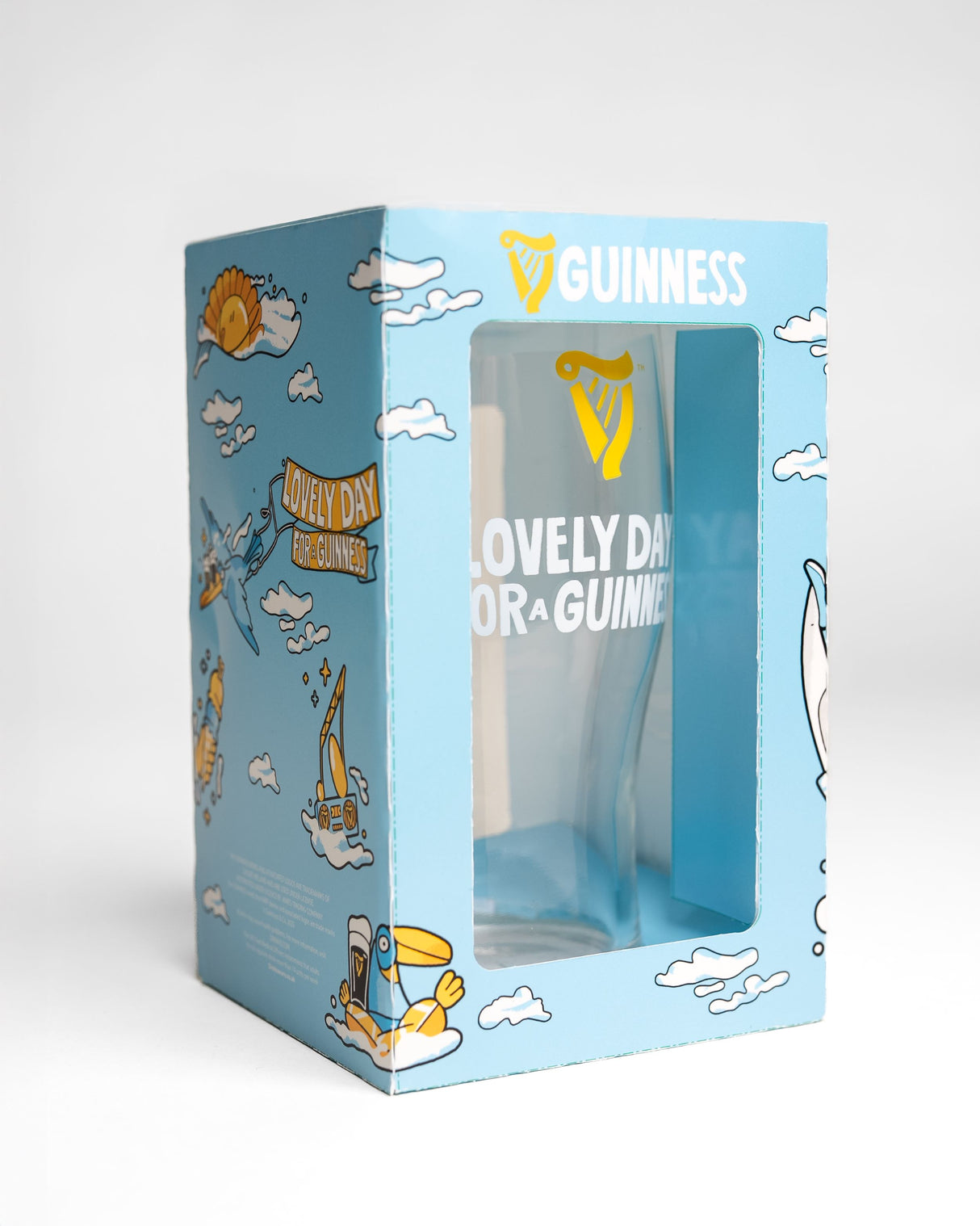 Guinness mug in a decorative box with cartoon designs on a light gray background