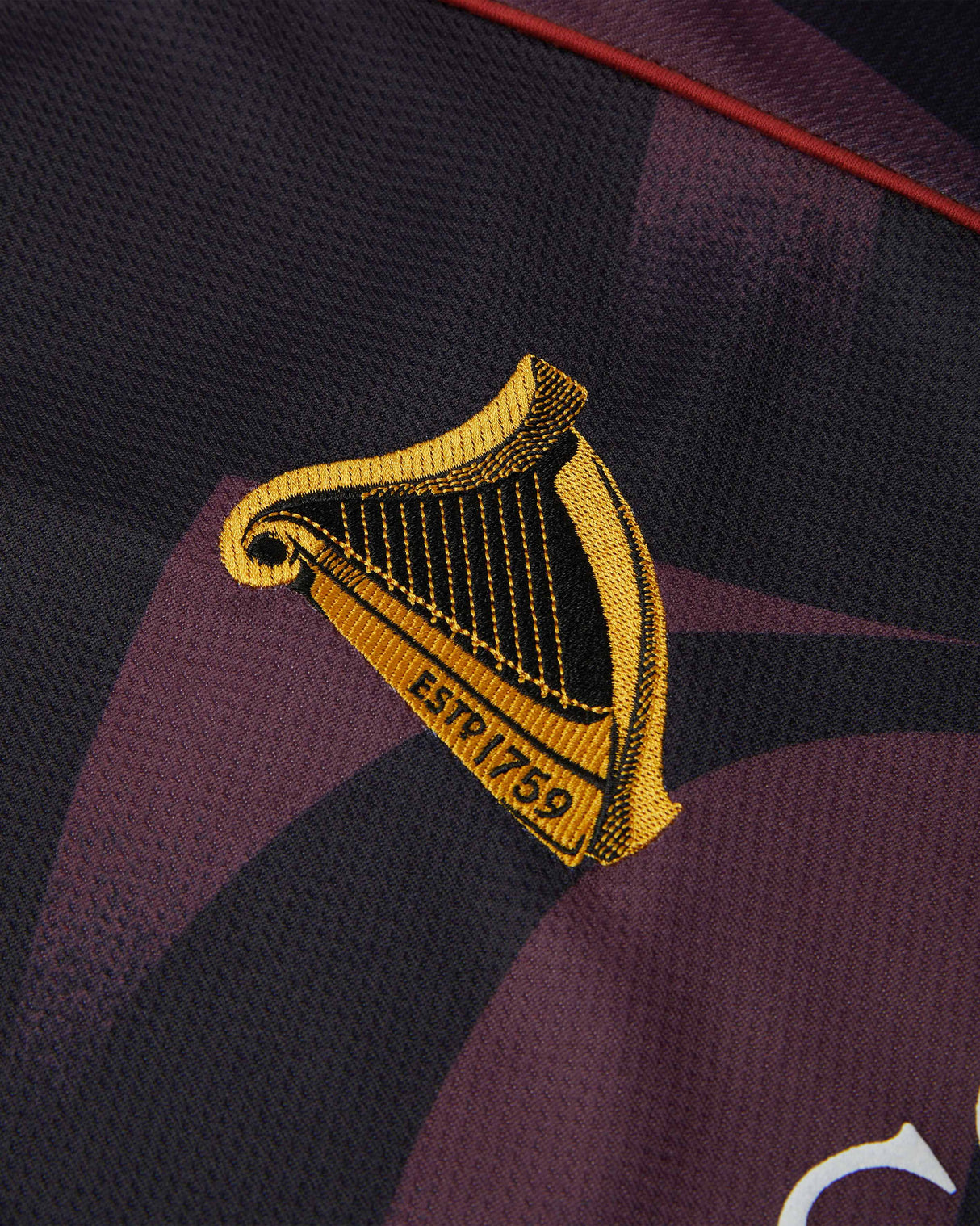 Close-up of a sports jersey with a yellow and black emblem on a dark background