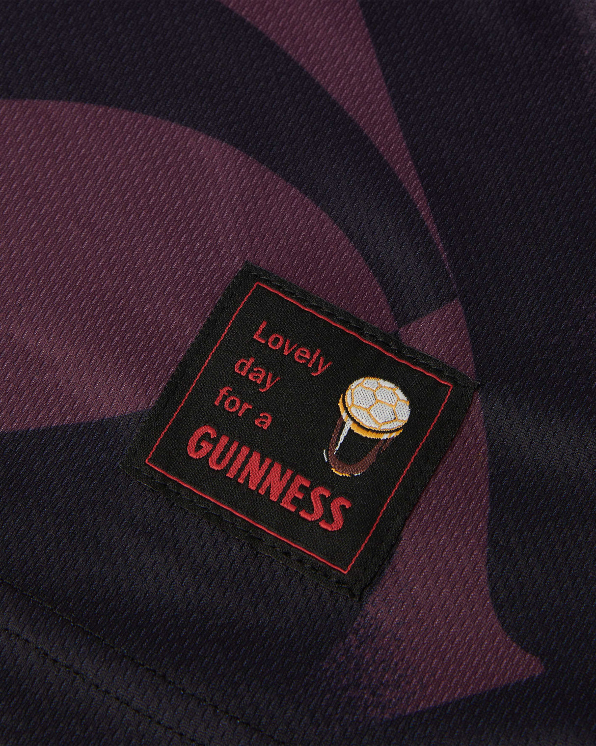 Patch with 'Lovely day for a Guinness' text on a dark fabric background