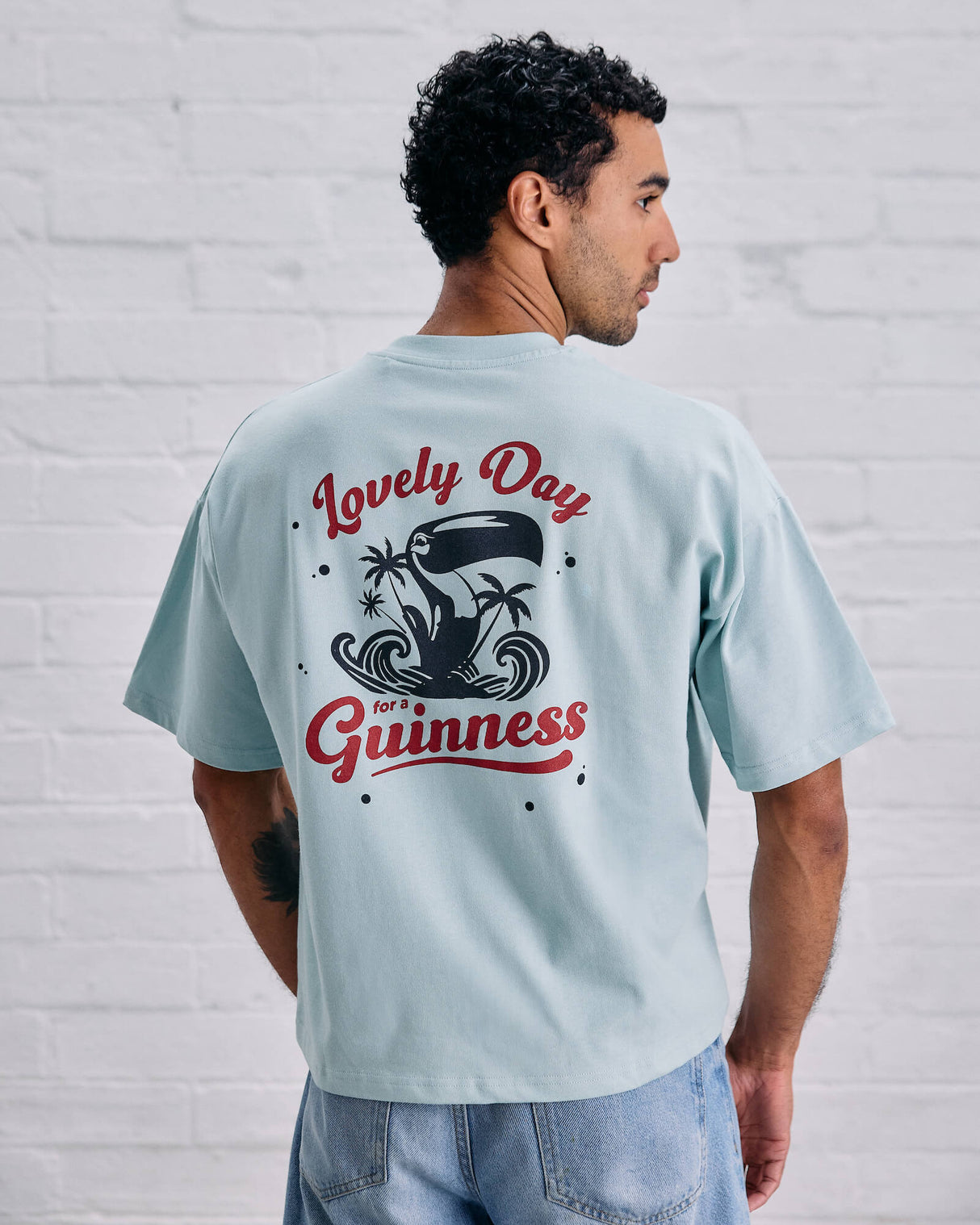 Model wearing the Guinness and Awave Apparel light blue, lovely day, t-shirt.