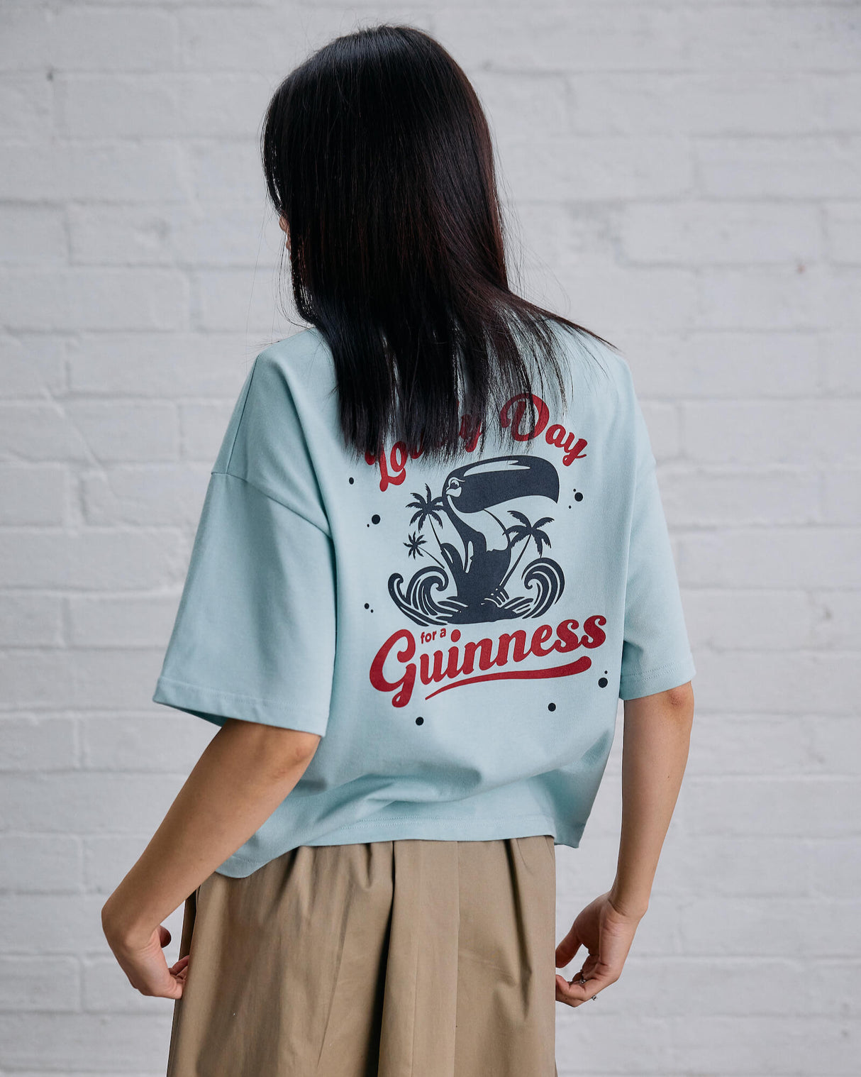 Model wearing the Guinness and Awave Apparel light blue, lovely day, t-shirt.