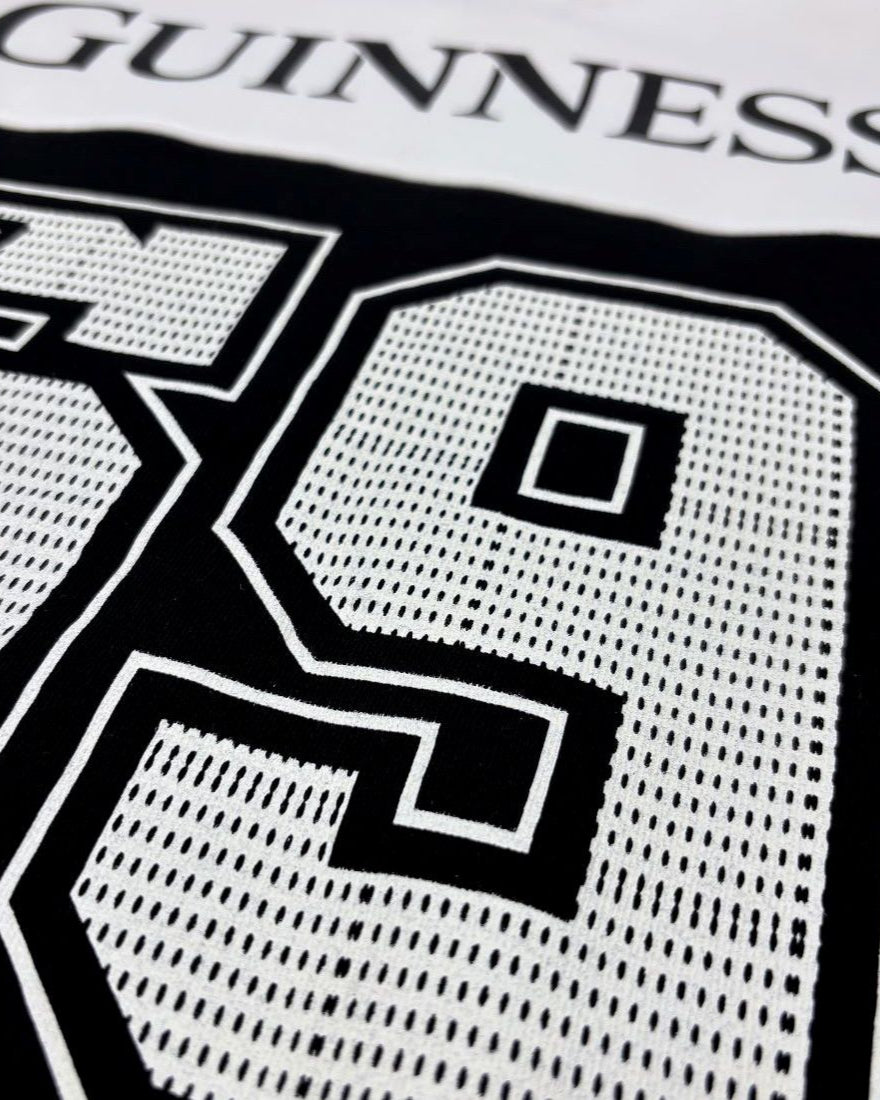 Close-up of a black and white pattern with 'Guinness' branding.