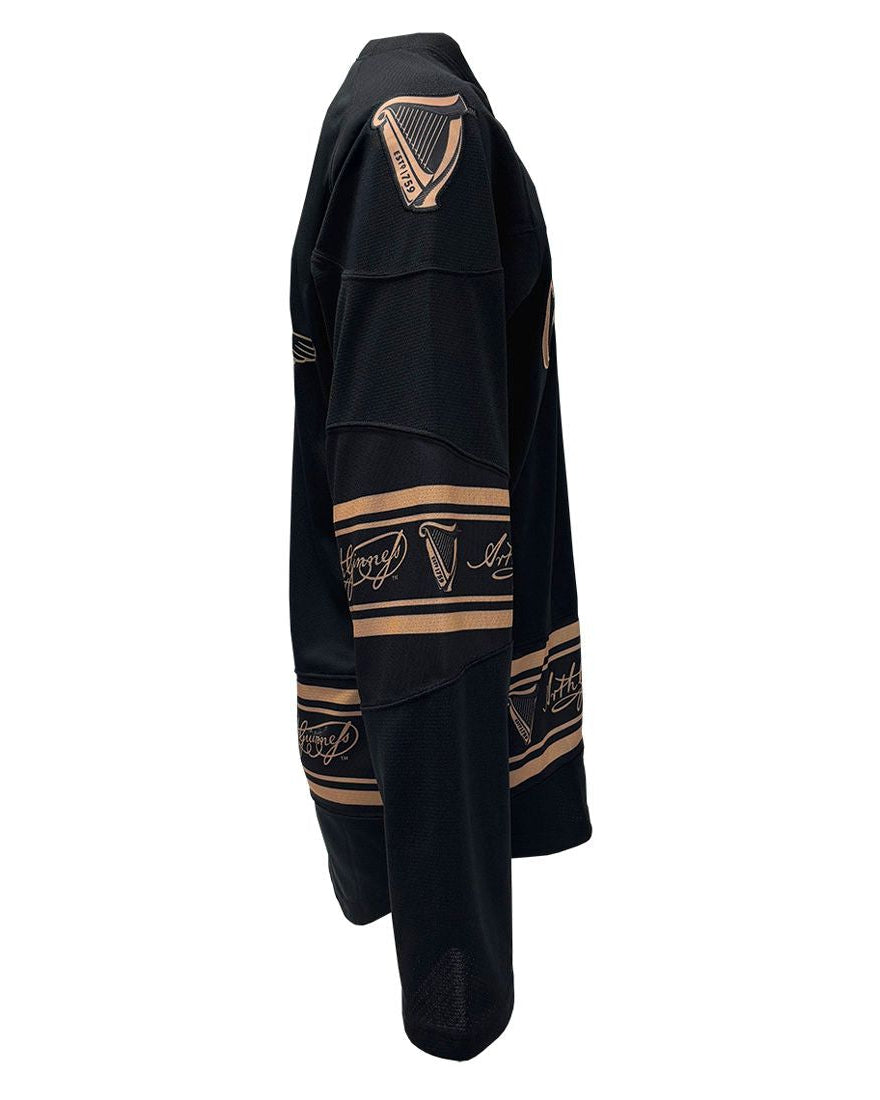 Black garment with gold embroidery on a white background