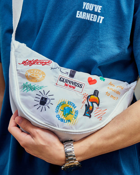 Detail shot of a man wearing the Guinness Storehouse, Dublin, Ireland, exclusive white belt bag.