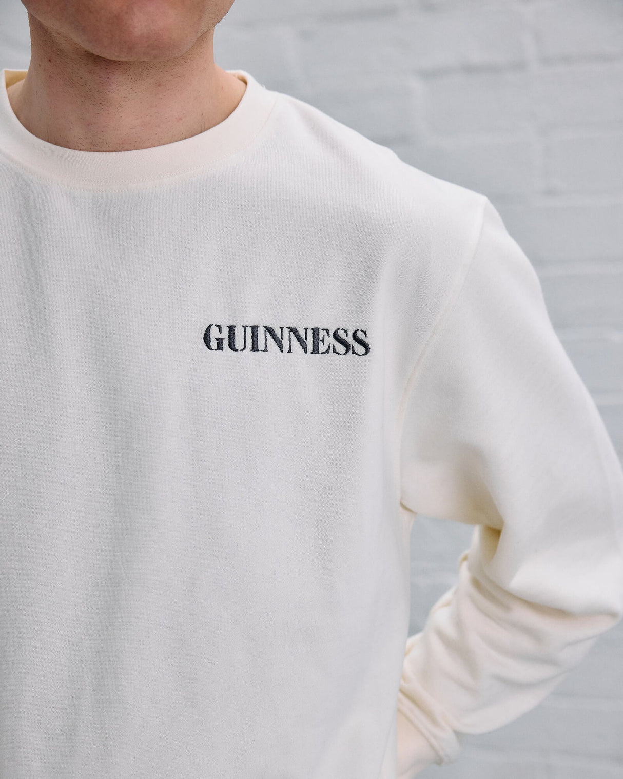 White sweatshirt with 'GUINNESS' text on a gray background