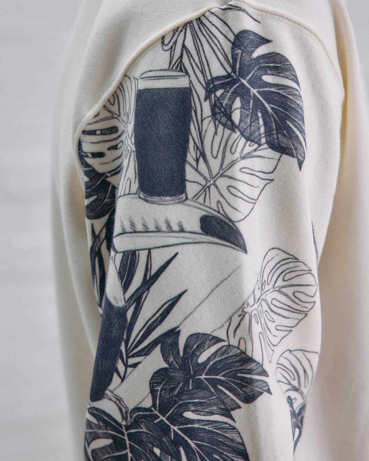 Close-up of a white garment with black leaf pattern