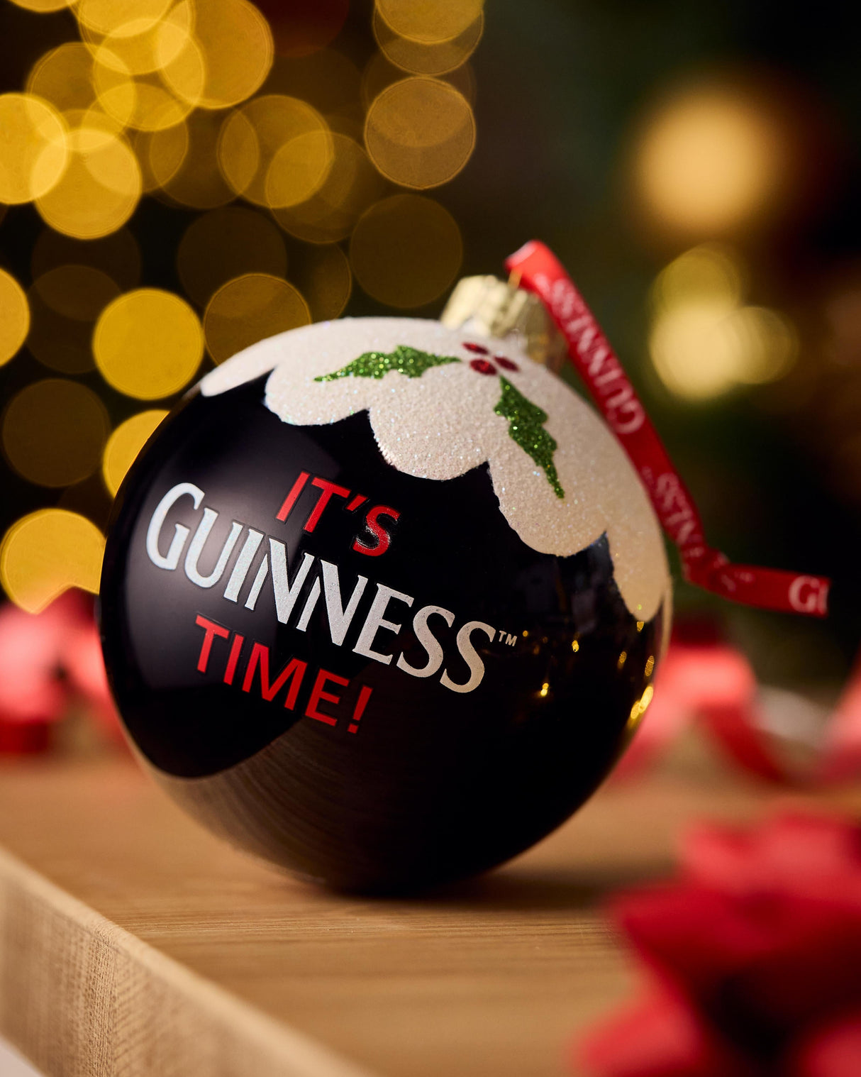 Guinness Christmas ornament with festive background