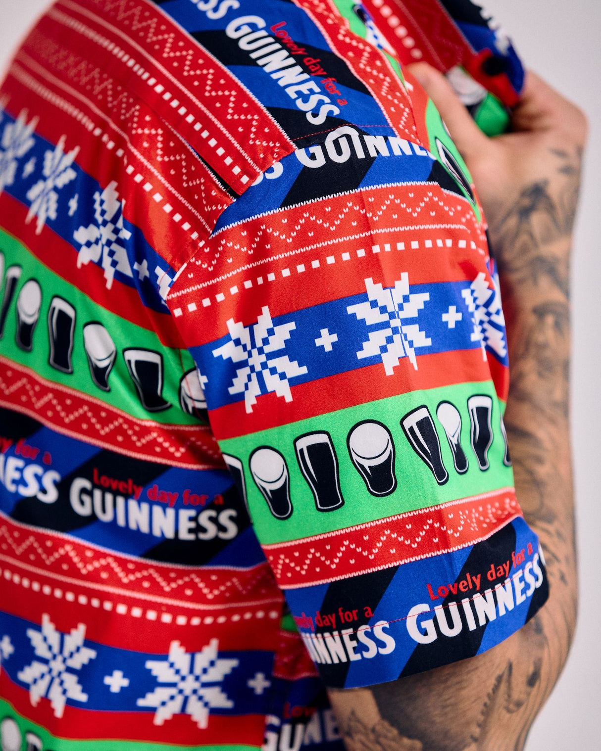 Close-up of a colorful Guinness shirt with patterns and text.