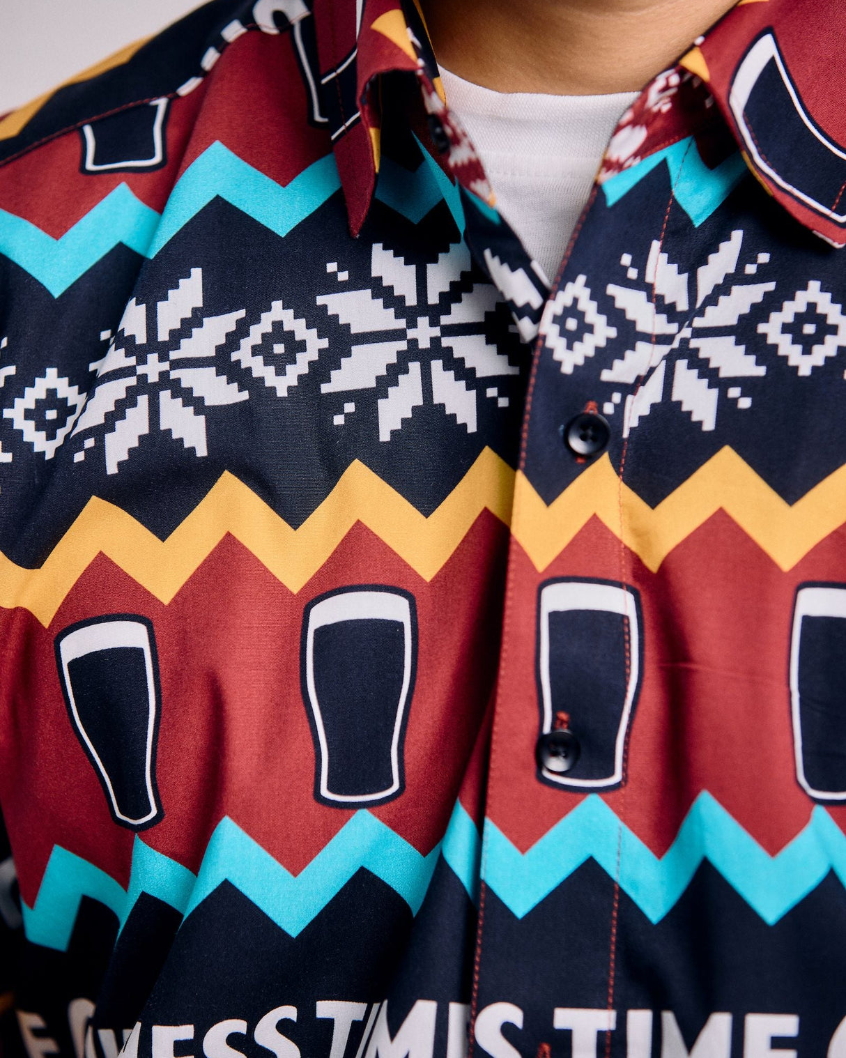 Close-up of a colorful patterned shirt with text and graphics.