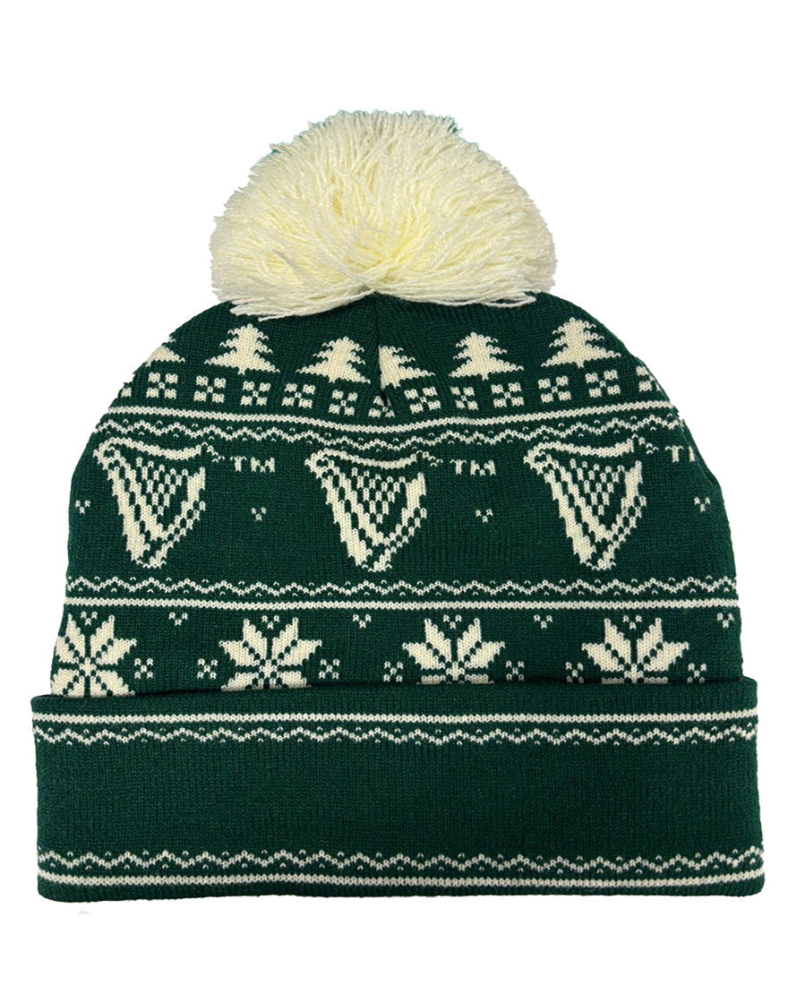 Green knit beanie with white patterns and pom-pom on a white background
