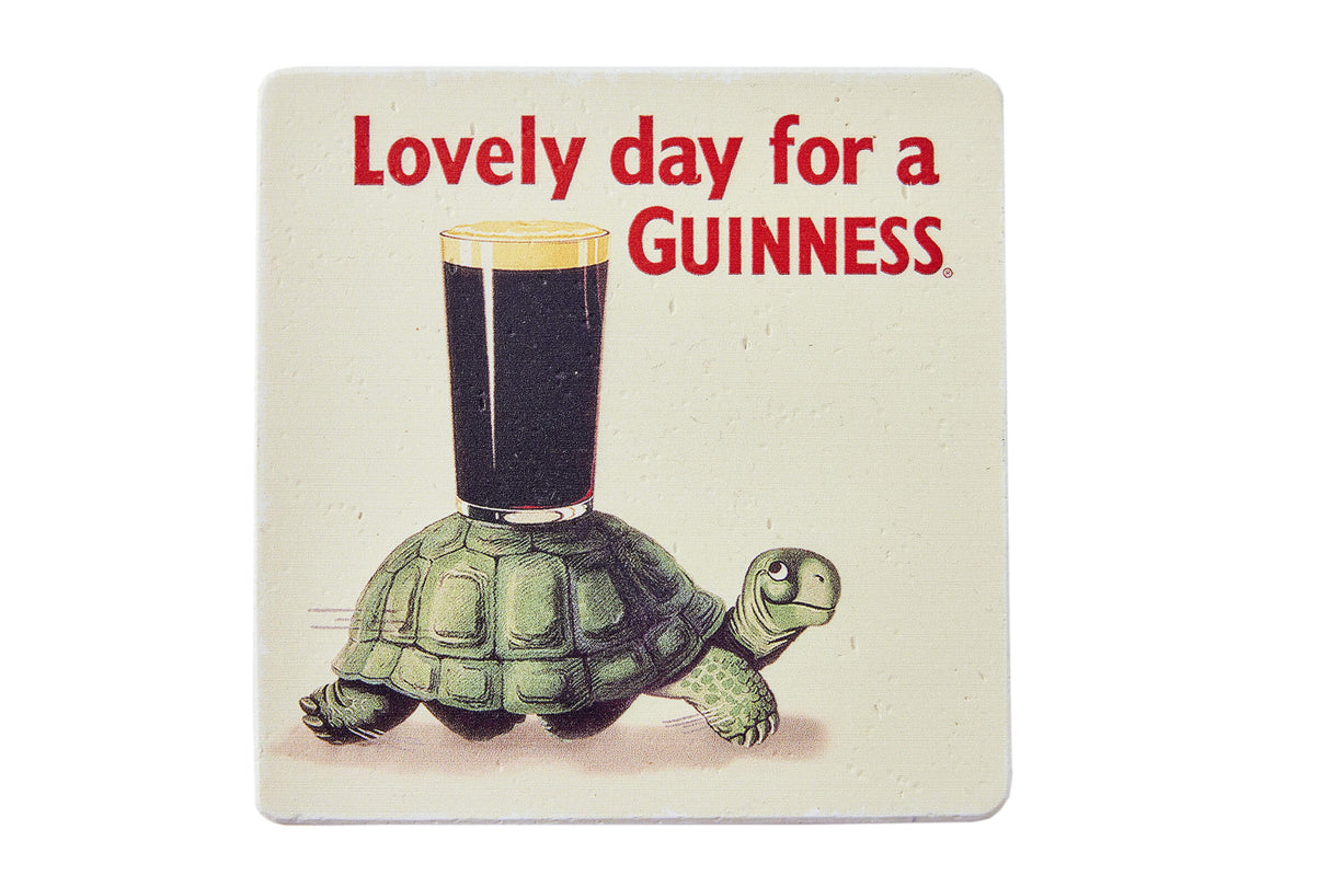 Coaster with a tortoise holding a glass of Guinness and text 'Lovely day for a GUINNESS'.