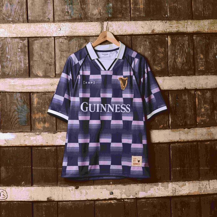 Image of Guinness x Art of Football jersey hanging on a barrel