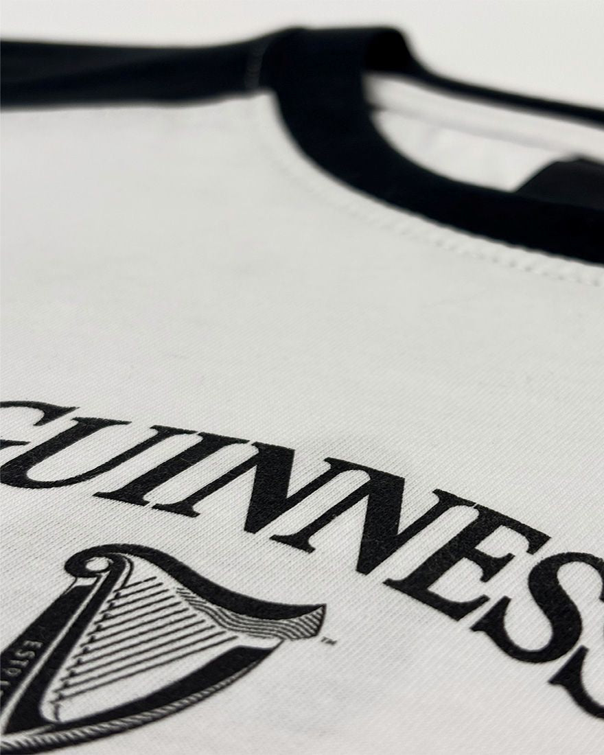 White shirt with black 'Guinness' logo on a white background