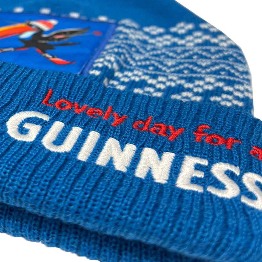 Blue knit beanie with 'Lovely day for a Guinness' text and pattern