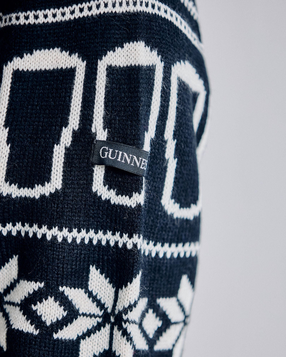 Black and white patterned fabric with a GUINNESS label on a light gray background