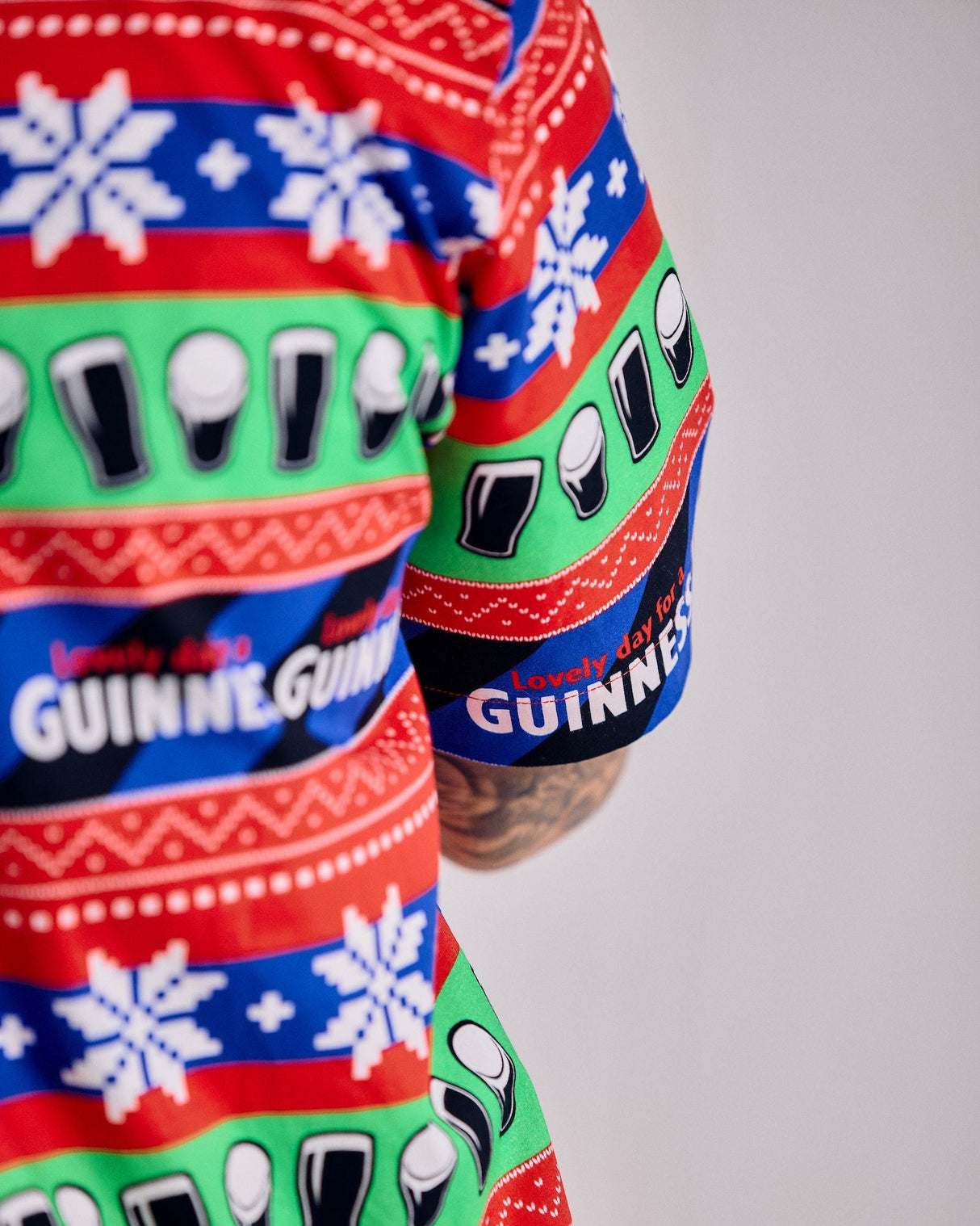Colorful patterned shirt with Guinness branding on a plain background