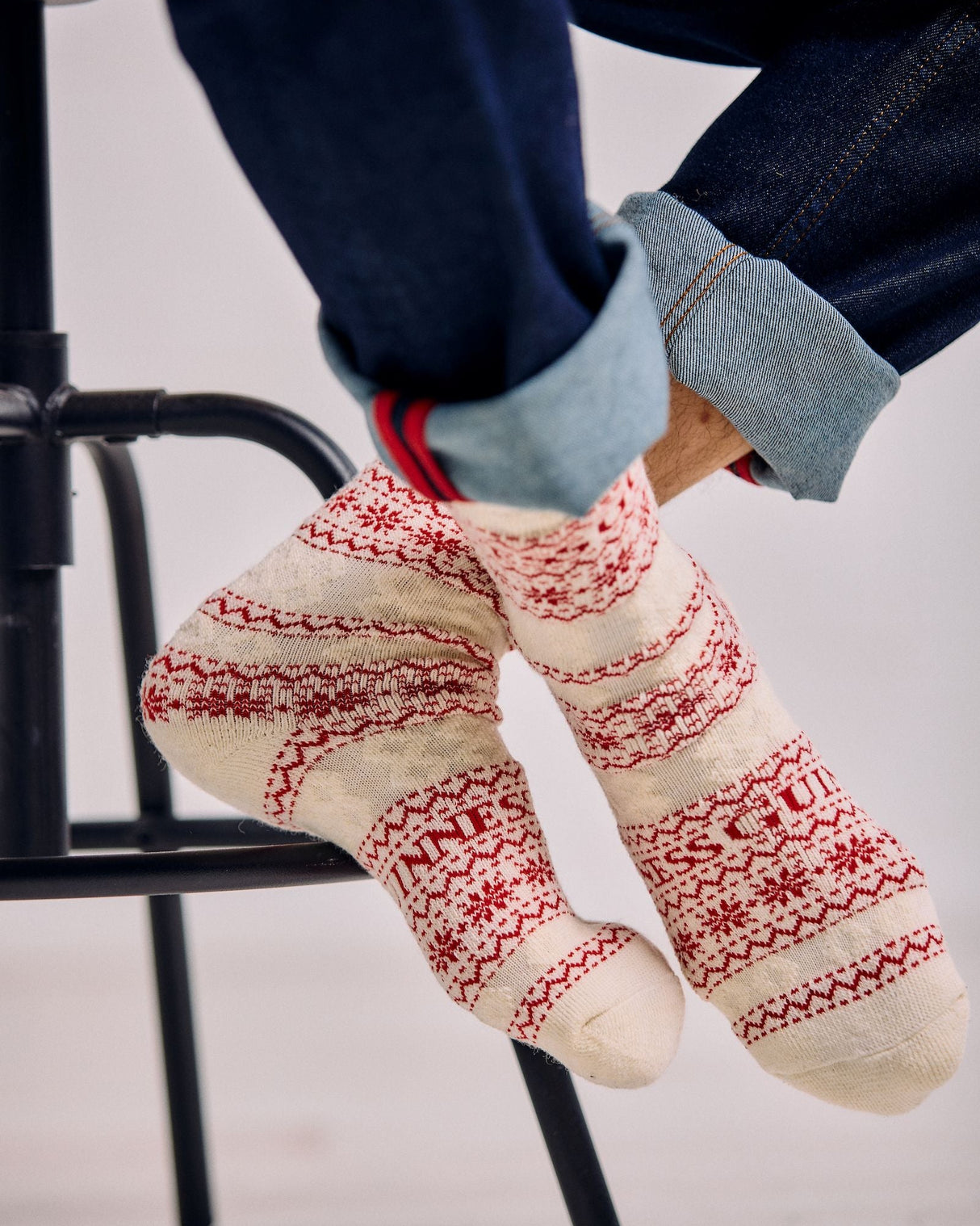 Person wearing patterned socks with a white background