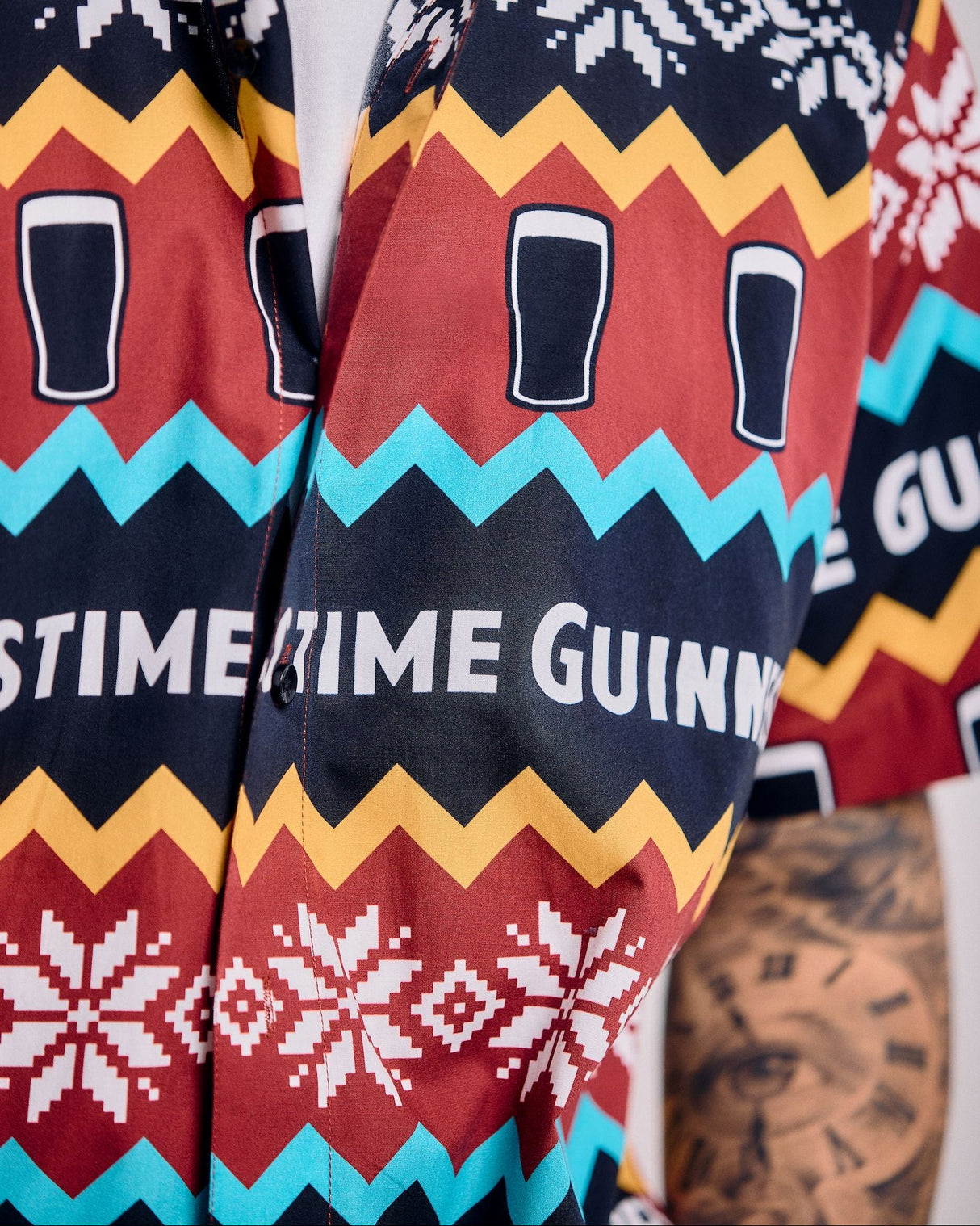 Colorful jacket with geometric patterns and text, worn by a person.