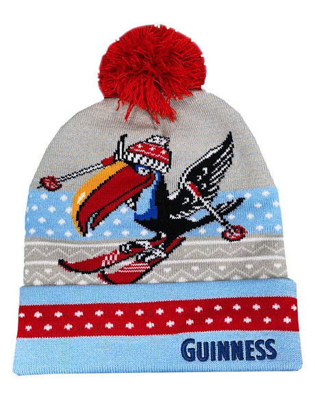 Knitted beanie with a red pom-pom, colorful design, and 'Guinness' branding on a white background.