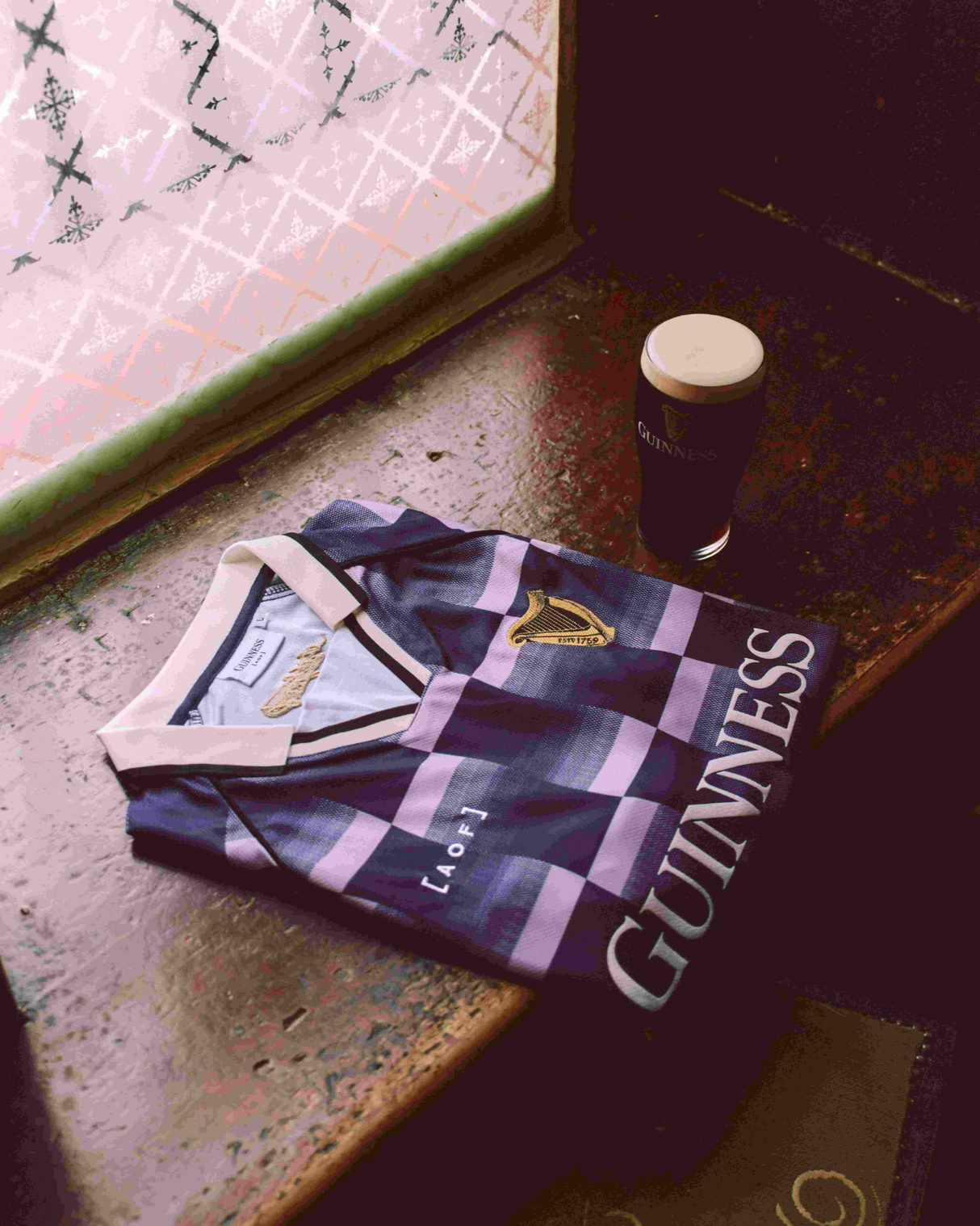 Image of Guinness x Art of Football jersey next to pint of Guinness