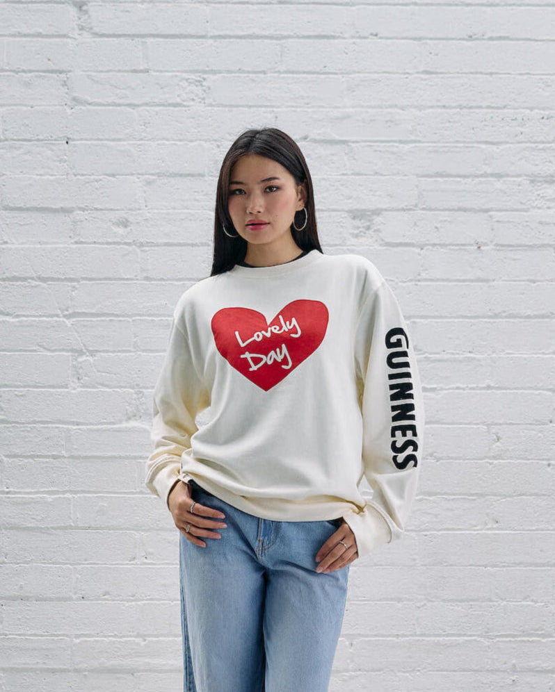 Model wearing the Guinness Storehouse Exclusive white sweater with the lovely day heart.
