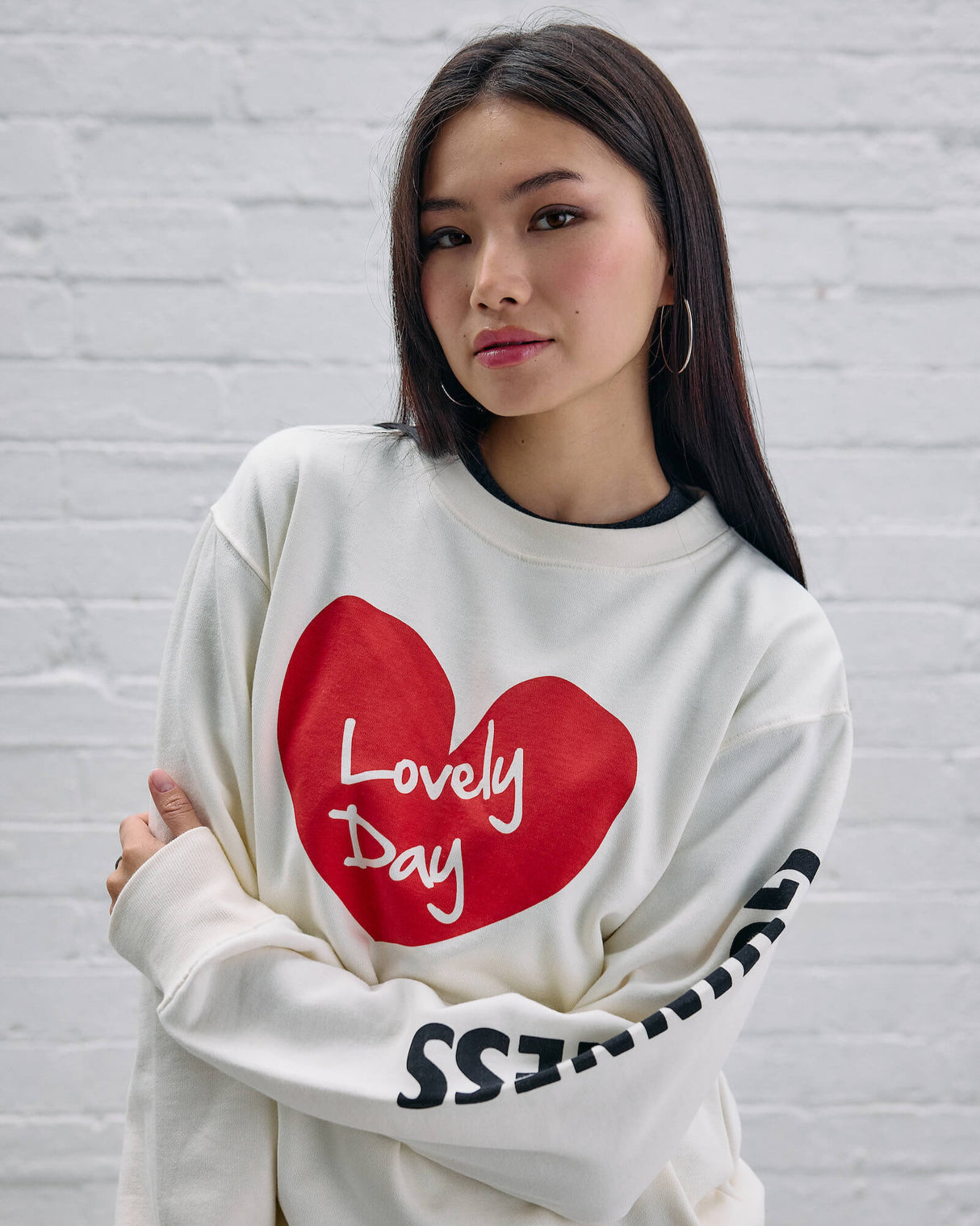 Model wearing the Guinness Storehouse Exclusive white sweater with the lovely day heart.