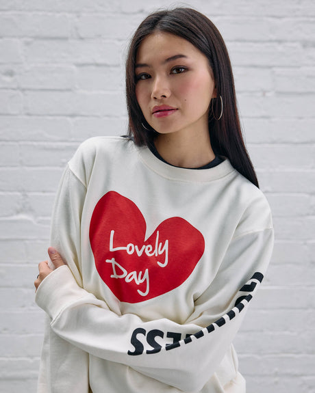 Model wearing the Guinness Storehouse Exclusive white sweater with the lovely day heart.
