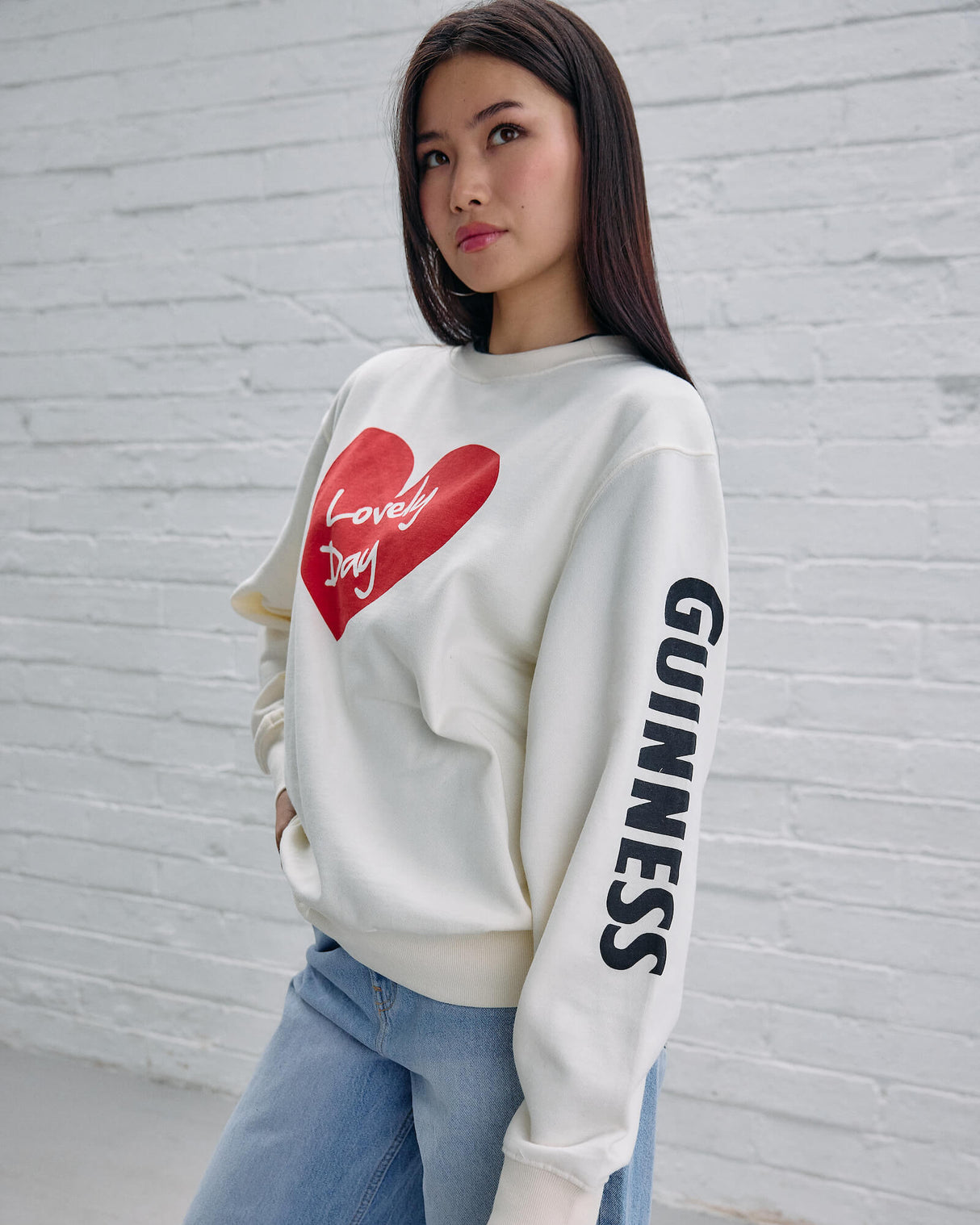 Model wearing the Guinness Storehouse Exclusive white sweater with the lovely day heart.