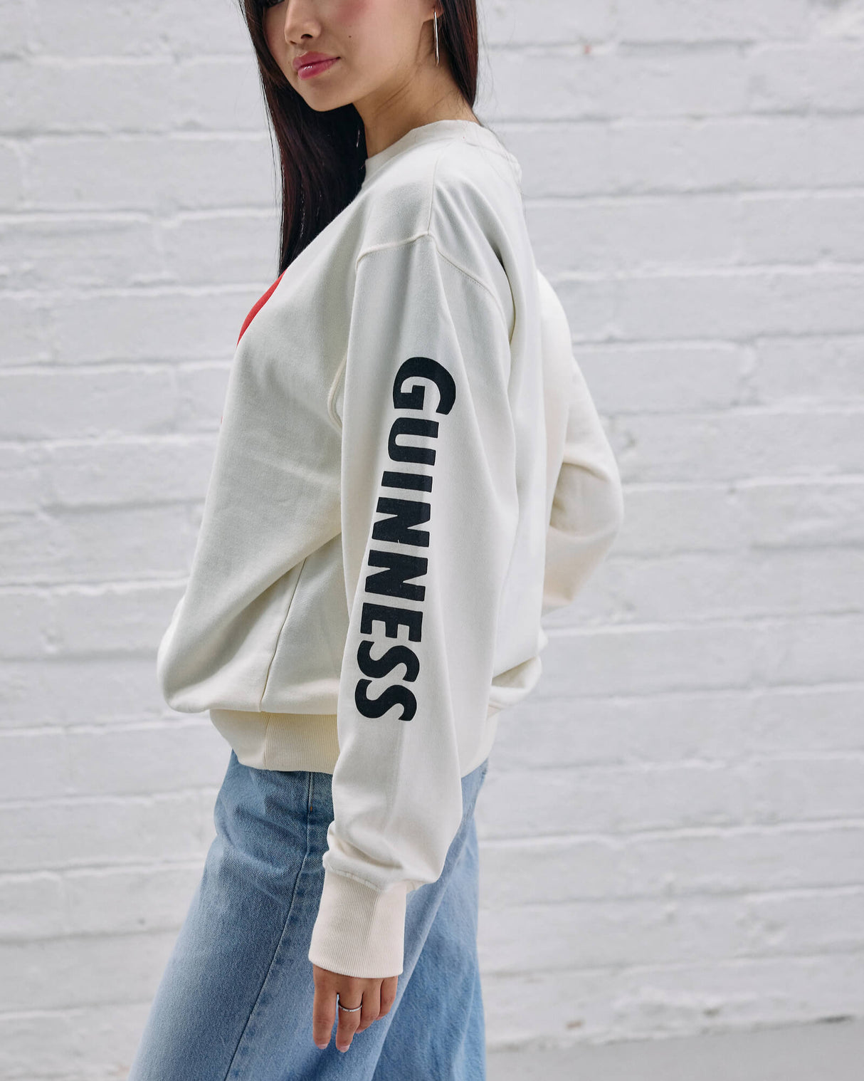 Model wearing the Guinness Storehouse Exclusive white sweater with the lovely day heart.