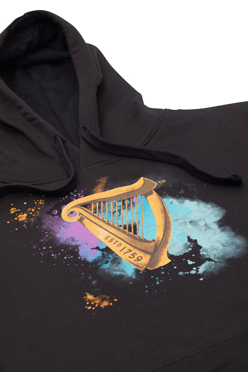 Detail of the Guinness Storehouse Exclusive hoodie with the iconic Guinness harp on watercolour texture.