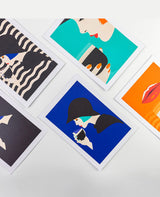Set of colorful art prints on a white surface