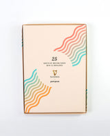 Pack of writing paper with colorful wave design on a white background