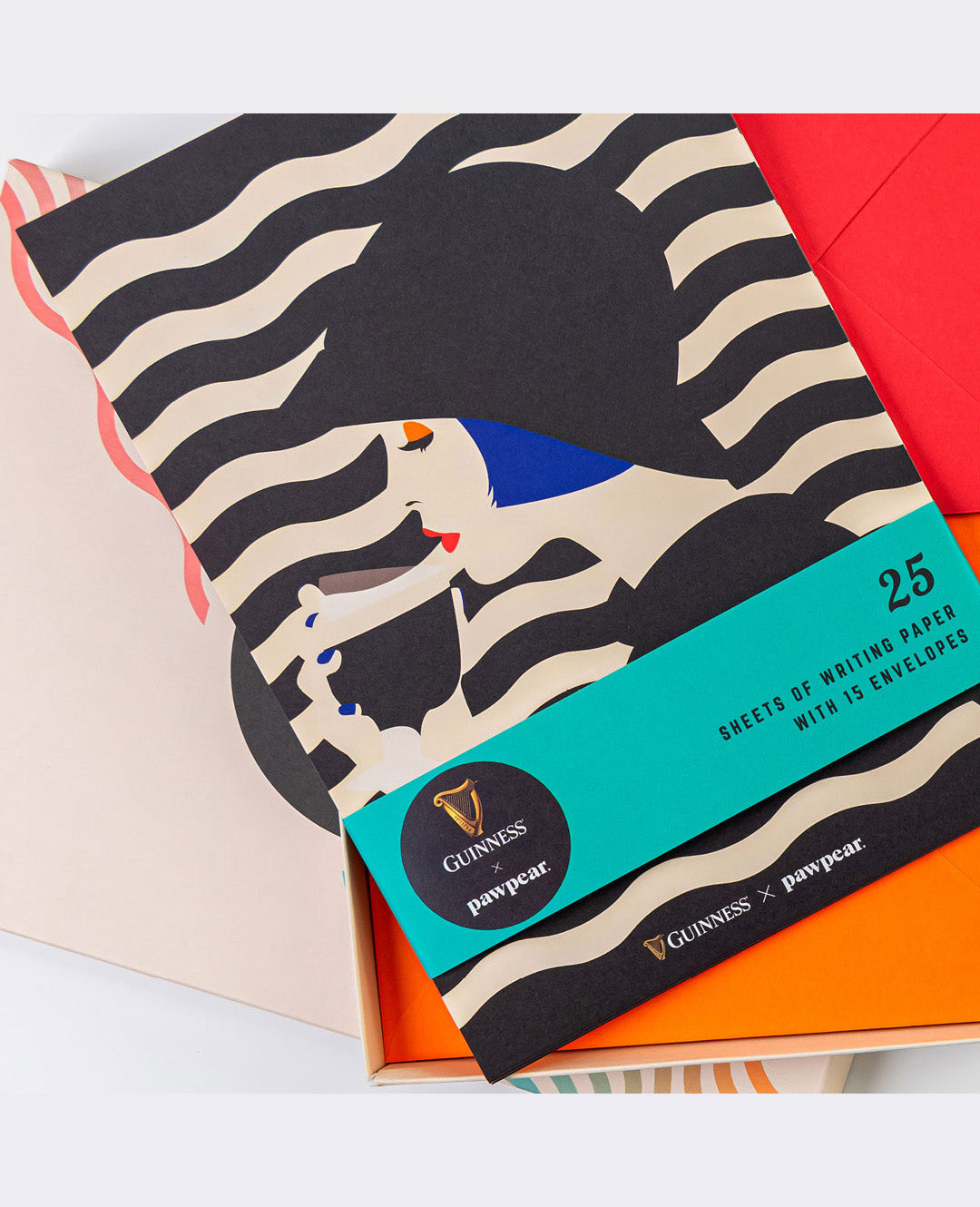 Pack of writing paper with zebra pattern and Guinness branding on a colorful background
