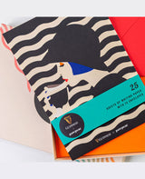 Pack of writing paper with zebra pattern and Guinness branding on a colorful background