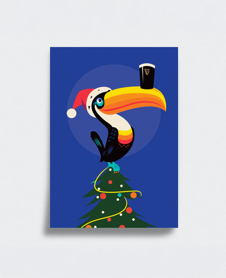 Colorful toucan in a Santa hat holding a pint glass on a Christmas tree against a blue background