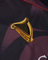Close-up of a sports jersey with a yellow and black emblem on a dark background