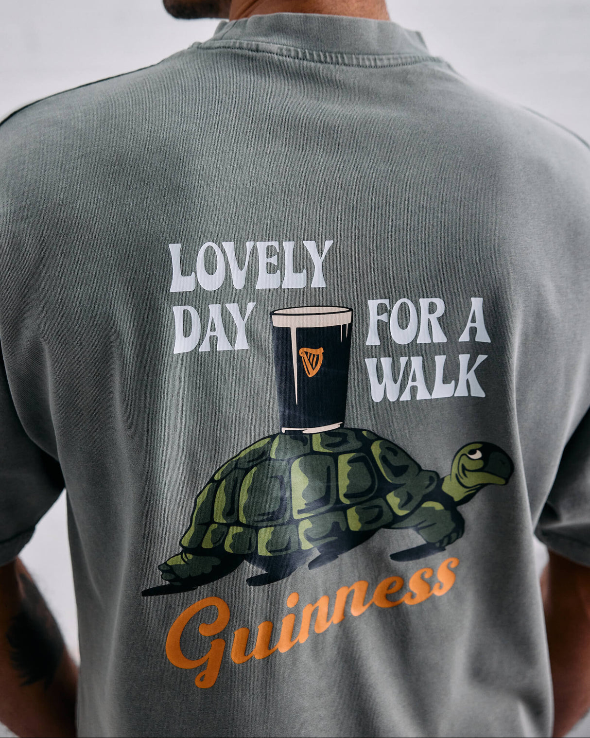 Image of the lovely date for a walk Awave and Guinness t-shirt. It feature a stylized design of the iconic Gilroy turtle with the Guinness pint.