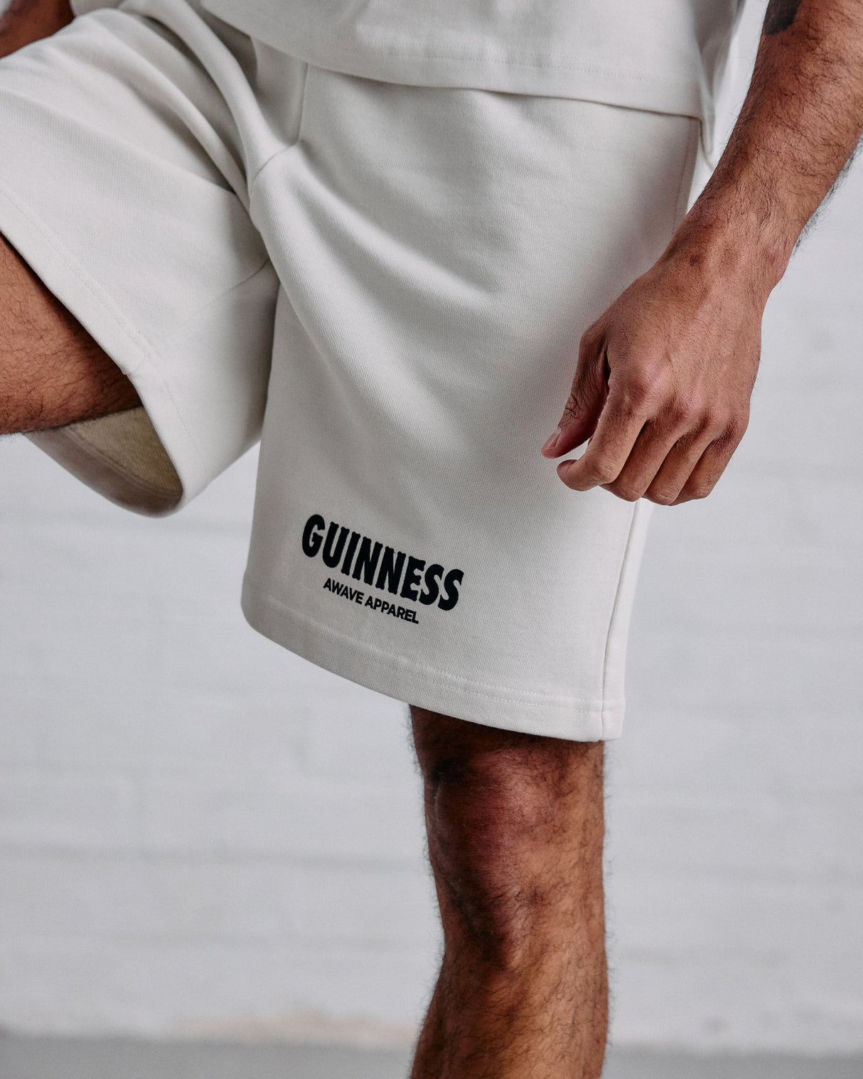 White shorts with 'Guinness' branding on a neutral background