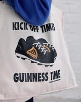 Model wearing the Guinness x Awave Apparel exclusive reusable bag featuring the Lovely Day for a Football design.