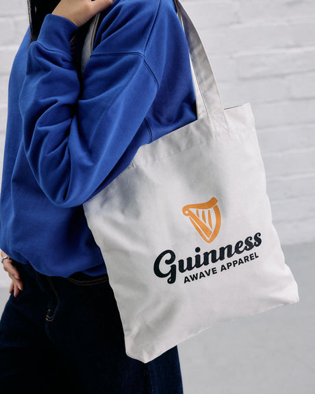 Model wearing the Guinness x Awave apparel milk carton reusable bag.