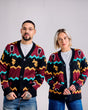 Two people wearing matching patterned cardigans against a plain background
