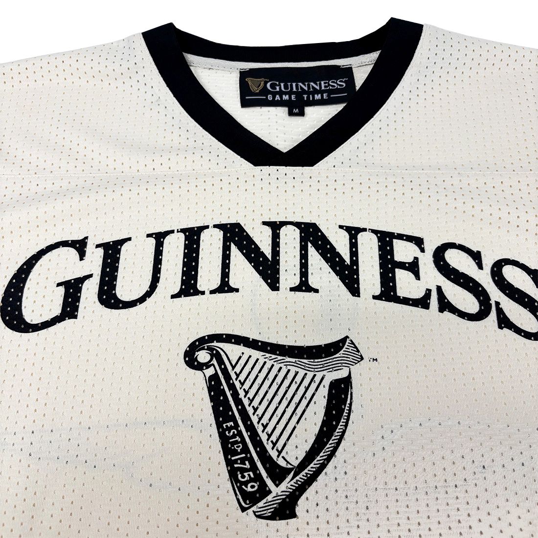 White jersey with black text and harp design, featuring the Guinness logo.