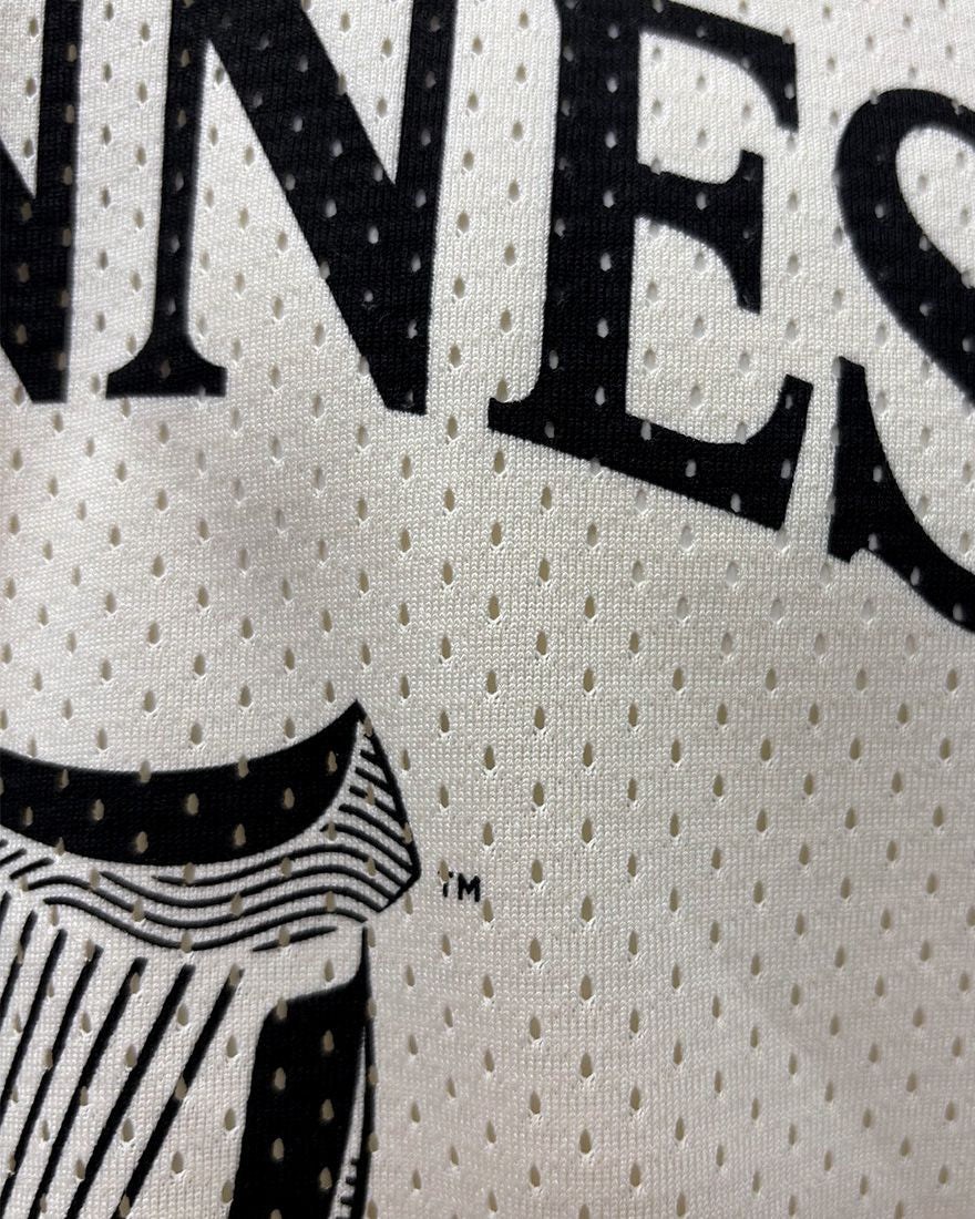 Close-up of a jersey with 'Guinness' branding on a white background