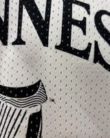 Close-up of a jersey with 'Guinness' branding on a white background